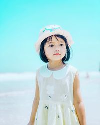 Portrait of cute girl standing against hat