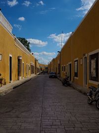 Narrow street amidst buildings against sky