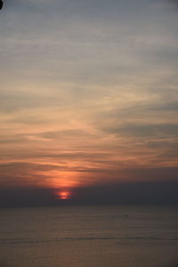 Scenic view of sea against romantic sky at sunset