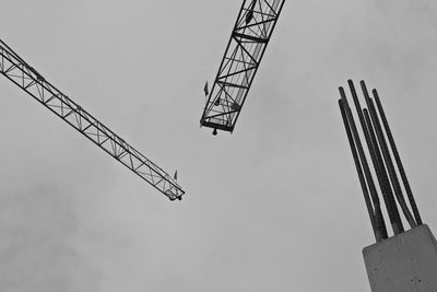 Low angle view of crane against sky