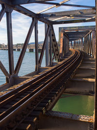 Bridge over sea against sky in city