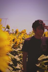 Man standing on field against yellow sky