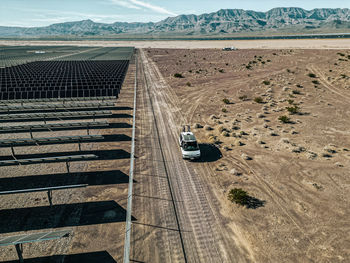 Off grid self contained campervan van life recreational vehicle parked next to a massive solar farm