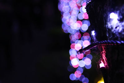 Close-up of illuminated lights against black background