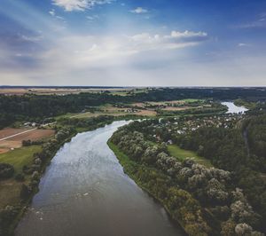 Scenic view of river amidst trees against sky