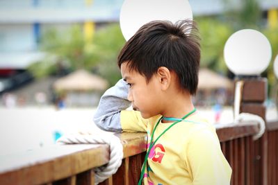 Side view of boy standing outdoors