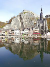 Reflection of buildings in lake against sky