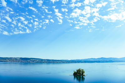 Scenic view of sea against blue sky