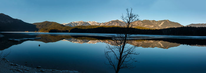 Scenic view of lake and mountains against sky