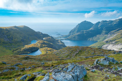 Scenic view of sea and mountains against sky