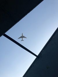 Low angle view of airplane flying in sky