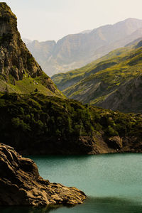 Scenic view of lake and mountains against sky