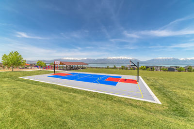 Information sign on field against sky