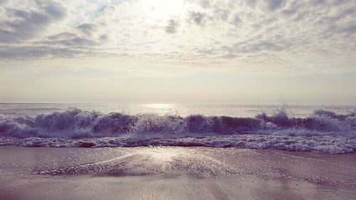 Scenic view of sea against cloudy sky