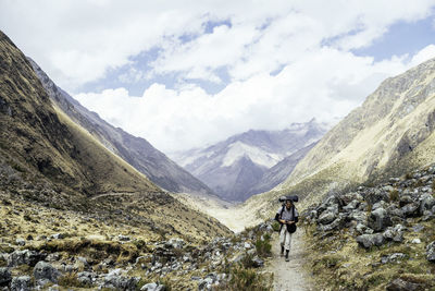 Rear view of people on mountain against sky