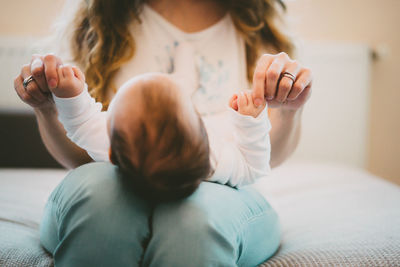 Close-up of mother with baby at home