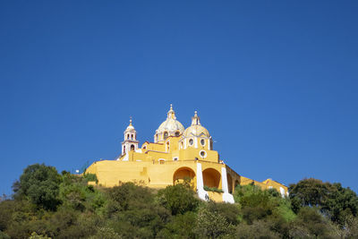 Low angle view of building against clear blue sky