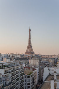 Buildings in city against clear sky