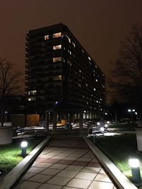 Illuminated cityscape against sky at night
