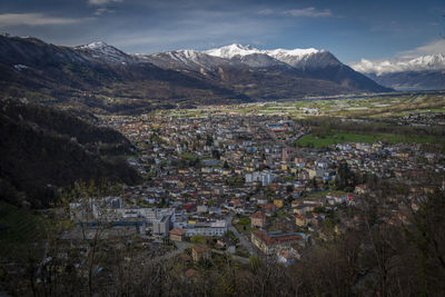 High angle view of townscape and mountains against sky