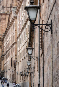 Low angle view of street light against building