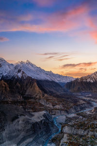 Scenic view of snowcapped mountains against sky during sunset