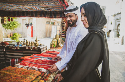 Couple buying clothing at market