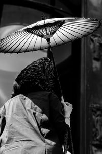 Close-up of boy holding umbrella