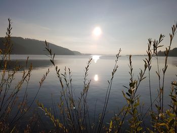 Scenic view of lake against sky during sunset