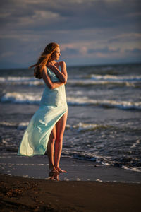 Woman with umbrella on beach