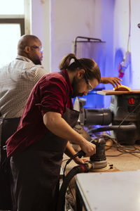 Side view of man working in workshop