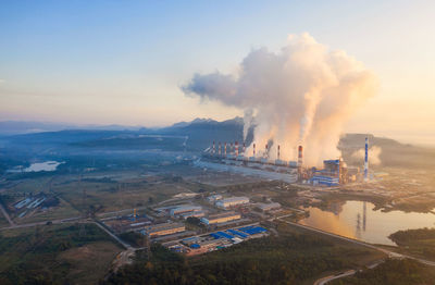 High angle view of smoke emitting from chimney against sky