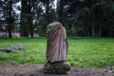 Stone sculpture on field in park