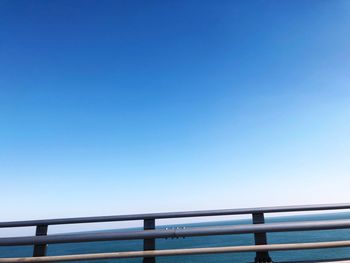 Low angle view of bridge against clear blue sky