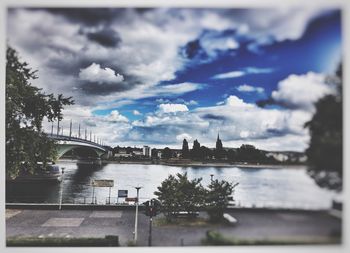 View of bridge over river against cloudy sky