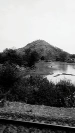 Scenic view of lake and mountains against clear sky