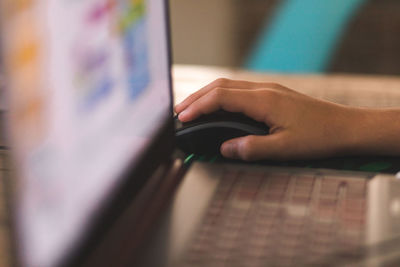 Boy with hand on mouse