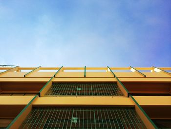 Low angle view of yellow building against sky