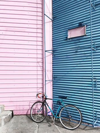 BICYCLE PARKED AGAINST WALL