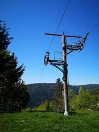 Low angle view of electricity pylon against sky