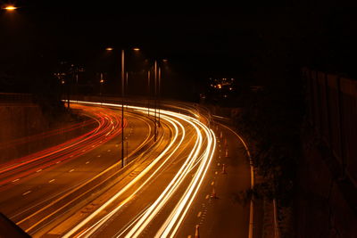 High angle view of light trails on road at night