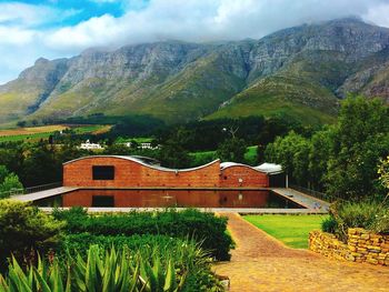 View of building and mountains against sky