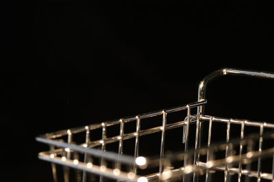 Close-up of illuminated lighting equipment against black background