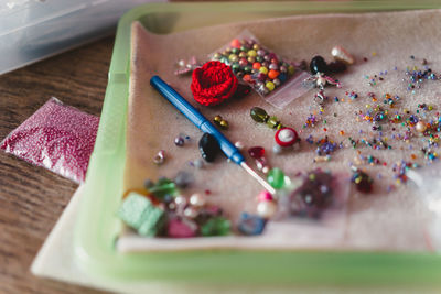 High angle view of multi colored sewing items on table