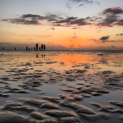 Scenic view of beach against sky during sunset