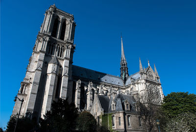 Low angle view of traditional building against clear blue sky