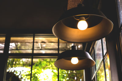 Inside the coffee shop is a large yellow-gold lamp. electrical appliances concept