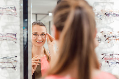 Young woman wearing mask in store