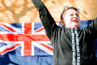 Full length of a boy with arms raised