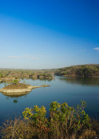 Scenic view of lake against blue sky